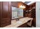 A granite-topped wood vanity with a built-in makeup desk and a large mirror at 65 Surfsong Rd, Kiawah Island, SC 29455
