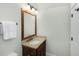 Bathroom vanity featuring granite countertops, a framed mirror, and a towel rack at 65 Surfsong Rd, Kiawah Island, SC 29455