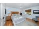 Bright bedroom featuring a ceiling fan, hardwood floors, and ensuite bathroom at 65 Surfsong Rd, Kiawah Island, SC 29455
