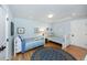 Bright bedroom featuring two twin beds with blue bedding, wood floors, and light blue walls at 65 Surfsong Rd, Kiawah Island, SC 29455