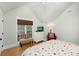 Bright bedroom with a queen bed, wood floors, and a window with a woven shade at 65 Surfsong Rd, Kiawah Island, SC 29455