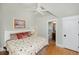 Bright bedroom featuring a king bed, ceiling fan, and doorway to the ensuite bathroom at 65 Surfsong Rd, Kiawah Island, SC 29455