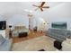 Spacious bedroom featuring hardwood floors, sofas, sitting area, ceilings fans and bright natural light at 65 Surfsong Rd, Kiawah Island, SC 29455