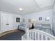 Bedroom features two beds with matching bedding, hardwood floors, and white trim at 65 Surfsong Rd, Kiawah Island, SC 29455