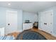 Bedroom showcasing hardwood floors, white trim, a closet and white dresser with TV at 65 Surfsong Rd, Kiawah Island, SC 29455