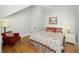 Bedroom with a queen bed, red chair, wood floors, and a white ceiling fan at 65 Surfsong Rd, Kiawah Island, SC 29455