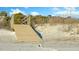 Wooden boardwalk leading to a sandy beach and dunes surrounded by vegetation at 65 Surfsong Rd, Kiawah Island, SC 29455