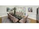 Elegant dining room featuring a glass table with seating for ten and natural light at 65 Surfsong Rd, Kiawah Island, SC 29455