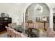 Bright dining room with a large glass table and striped chairs with a view to the living area at 65 Surfsong Rd, Kiawah Island, SC 29455