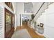 Bright foyer featuring high ceilings, wood floors, stairs, and a formal entryway with a rug at 65 Surfsong Rd, Kiawah Island, SC 29455