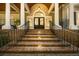 Grand entrance featuring brick steps, iron railings, and elegant columns at 65 Surfsong Rd, Kiawah Island, SC 29455