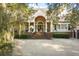 Charming home featuring a symmetrical facade, columns, and a brick stairway leading to the front door at 65 Surfsong Rd, Kiawah Island, SC 29455