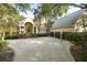 Inviting home with a large driveway, well-manicured landscaping, and an attached three car garage at 65 Surfsong Rd, Kiawah Island, SC 29455