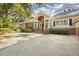 Expansive front yard with a large driveway and lush landscaping surrounds this elegant home at 65 Surfsong Rd, Kiawah Island, SC 29455