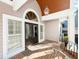 Charming front porch featuring brick flooring, decorative columns, and elegant double doors at 65 Surfsong Rd, Kiawah Island, SC 29455