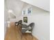 Hallway featuring two wicker chairs, hardwood floors, and white wainscoting at 65 Surfsong Rd, Kiawah Island, SC 29455