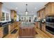 Spacious kitchen features custom cabinets, stainless steel appliances, and a large island at 65 Surfsong Rd, Kiawah Island, SC 29455