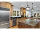 Kitchen boasts stainless steel appliances, granite countertops, and a large central island at 65 Surfsong Rd, Kiawah Island, SC 29455