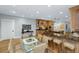 Open kitchen layout with a central island, wooden cabinets, and a breakfast bar at 65 Surfsong Rd, Kiawah Island, SC 29455