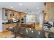 Open kitchen layout features custom wooden cabinets, granite counters and stainless steel appliances at 65 Surfsong Rd, Kiawah Island, SC 29455