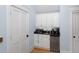 This kitchenette features white cabinets, stainless steel refrigerator and a microwave oven at 65 Surfsong Rd, Kiawah Island, SC 29455