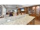 Spacious living room featuring wooden built-ins, a stone fireplace, and a view of the bar area at 65 Surfsong Rd, Kiawah Island, SC 29455