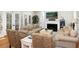 Inviting living room featuring comfortable sofas, fireplace, and plenty of natural light from large windows at 65 Surfsong Rd, Kiawah Island, SC 29455