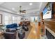 Open-concept living room features hardwood floors, fireplace, and adjacent dining area at 65 Surfsong Rd, Kiawah Island, SC 29455