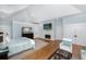 This main bedroom features vaulted ceilings, hardwood floors, and a cozy fireplace with a television above at 65 Surfsong Rd, Kiawah Island, SC 29455
