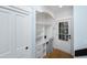 Bright office nook with built-in shelving and drawers, a desk, and a door to the backyard at 65 Surfsong Rd, Kiawah Island, SC 29455