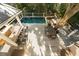 A beautiful backyard pool area with an outdoor dining and lounging space at 65 Surfsong Rd, Kiawah Island, SC 29455