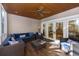 Comfortable screened-in porch with stylish furniture, a ceiling fan, and sliding glass doors to the outside at 65 Surfsong Rd, Kiawah Island, SC 29455