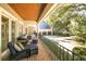Cozy porch with views of the backyard, surrounded by lush greenery and a three car garage at 65 Surfsong Rd, Kiawah Island, SC 29455