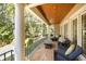 Relaxing porch with comfortable seating and a view of the lush surroundings at 65 Surfsong Rd, Kiawah Island, SC 29455