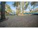 A private backyard featuring mature trees, fenced yard, in-ground pool, and an outbuilding at 676 Sterling Dr, Charleston, SC 29412