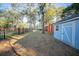 Expansive backyard featuring mature trees, ample space, and a charming storage shed at 676 Sterling Dr, Charleston, SC 29412
