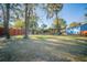 Lush backyard with mature trees, a fenced pool, storage building, and green space perfect for entertaining at 676 Sterling Dr, Charleston, SC 29412