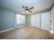 Neutral bedroom with wood floor, white doors and a ceiling fan at 676 Sterling Dr, Charleston, SC 29412