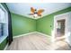 Bedroom with wood floors, window, and a view of adjoining room at 676 Sterling Dr, Charleston, SC 29412