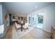 Open-concept dining room with modern table, chairs, and sliding glass doors to an outdoor patio at 676 Sterling Dr, Charleston, SC 29412