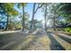 Beautiful home with mature trees creating shade and a well-manicured front yard at 676 Sterling Dr, Charleston, SC 29412