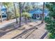 Charming single-story home featuring a covered porch, mature trees, and a well-maintained front yard at 676 Sterling Dr, Charleston, SC 29412