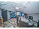 Finished attic bonus room featuring a poker table, arcade games, funky ceiling and custom carpet at 676 Sterling Dr, Charleston, SC 29412