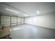 Clean, empty garage with white walls, grey floor, overhead lighting, window, and automatic garage door at 676 Sterling Dr, Charleston, SC 29412