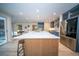 Spacious kitchen with stainless steel appliances, large island, and stylish blue cabinetry at 676 Sterling Dr, Charleston, SC 29412