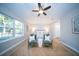 Bright main bedroom with natural light, wood floors, and cozy seating at 676 Sterling Dr, Charleston, SC 29412