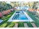 Aerial view of a backyard with a sparkling pool, lounge chairs, and manicured artificial turf at 676 Sterling Dr, Charleston, SC 29412