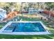 Aerial view of a backyard with a sparkling pool, lounge chairs, and manicured artificial turf at 676 Sterling Dr, Charleston, SC 29412