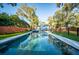 Stunning pool reflecting the home, set amongst landscaped grounds and mature trees at 676 Sterling Dr, Charleston, SC 29412