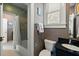 Cozy bathroom featuring a granite vanity, ample natural light and tiled shower at 7 West St # C, Charleston, SC 29401